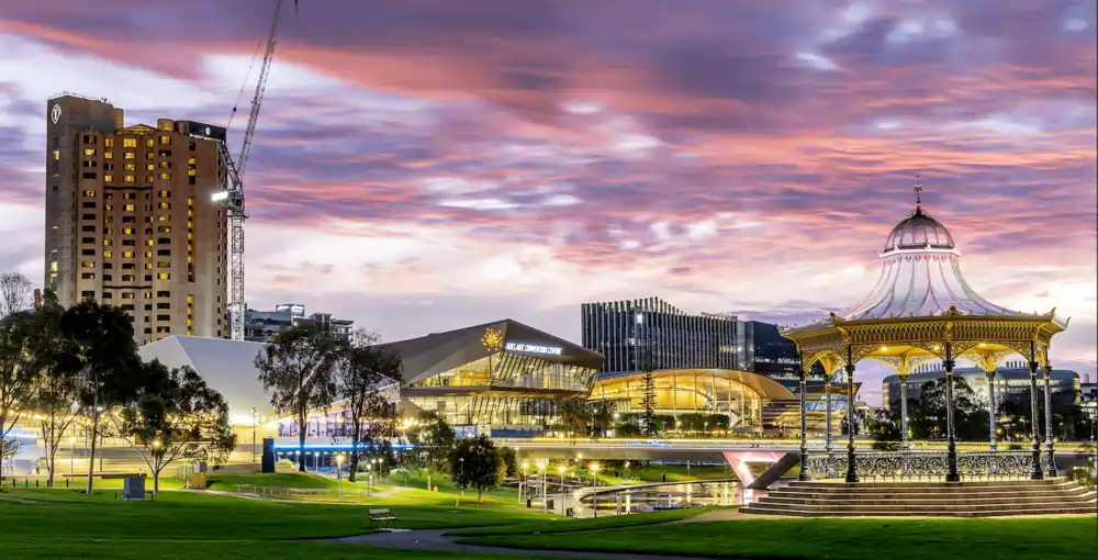 Elder Park rotunda and Adelaide Convention Centre at sunset